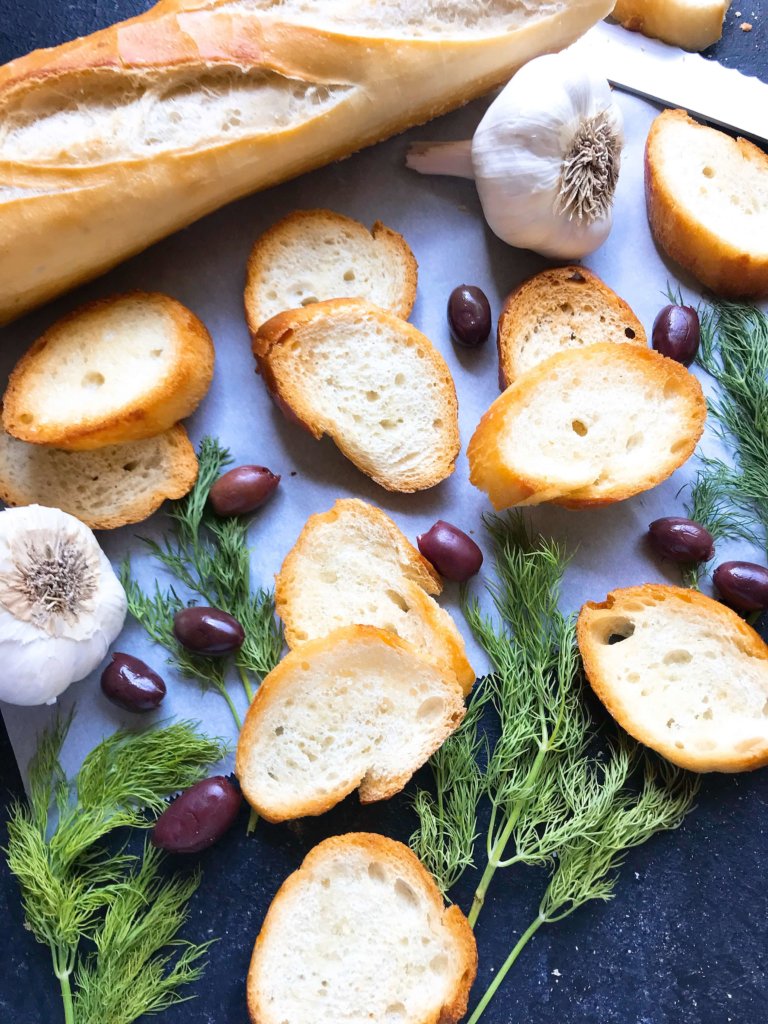 10 minutes to make toasted bread crostini! A perfect appetizer for game day, parties, and holiday entertaining. Top with your favorite spread or dip. Vegan and vegetarian recipe. How To Make Crostini | Three Olives Branch | www.threeolivesbranch.com #holidayappetizer #veganrecipe 