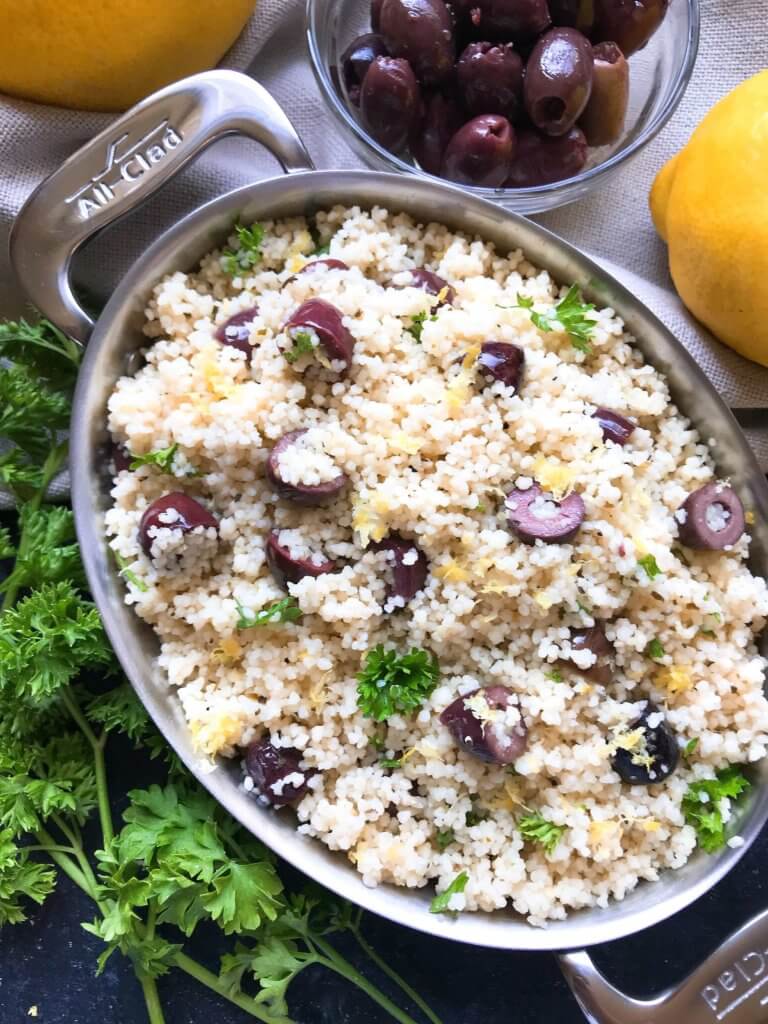 Ready in less than 10 minutes, this Vegan Mediterranean Lemon Olive Couscous recipe is full of fresh and bright flavors for a light side dish. Great with chicken, seafood, and vegetables. A simple and easy recipe to make. #fastrecipes #olives #lemon #sidedishrecipes