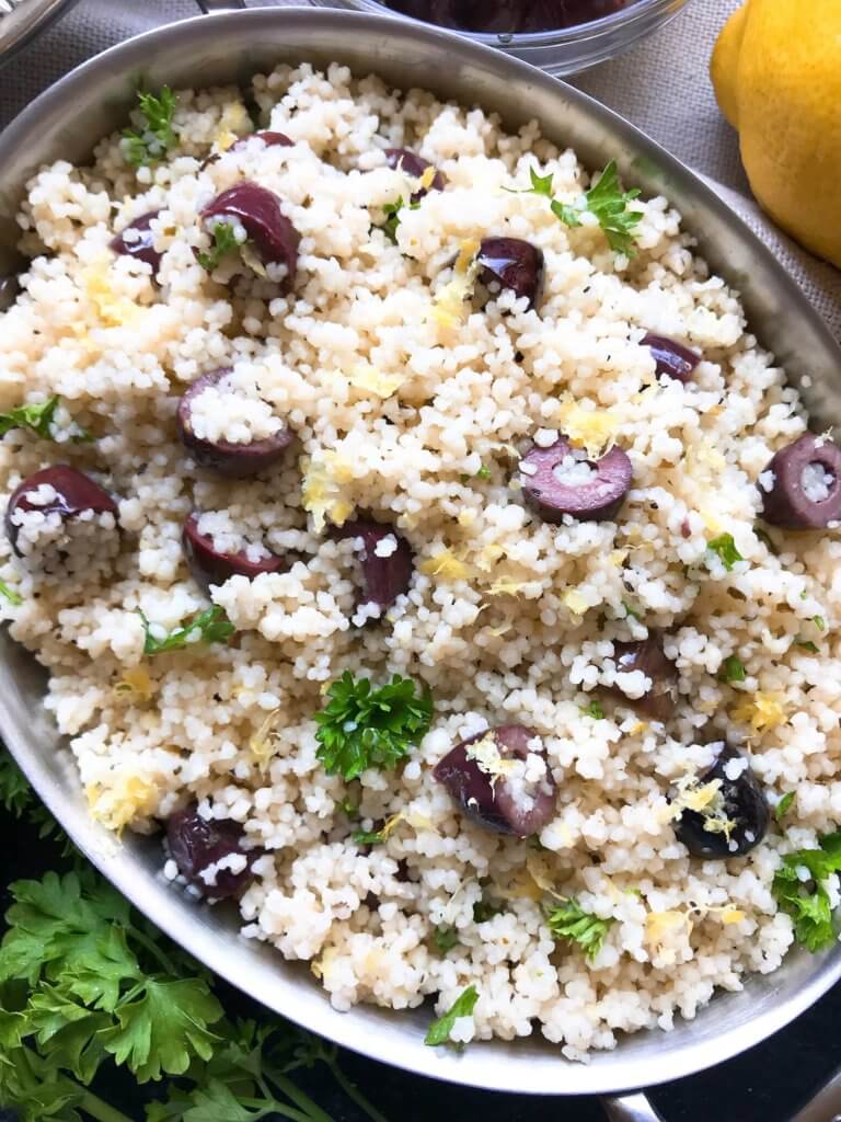 Ready in less than 10 minutes, this Vegan Mediterranean Lemon Olive Couscous recipe is full of fresh and bright flavors for a light side dish. Great with chicken, seafood, and vegetables. A simple and easy recipe to make. #fastrecipes #olives #lemon #sidedishrecipes