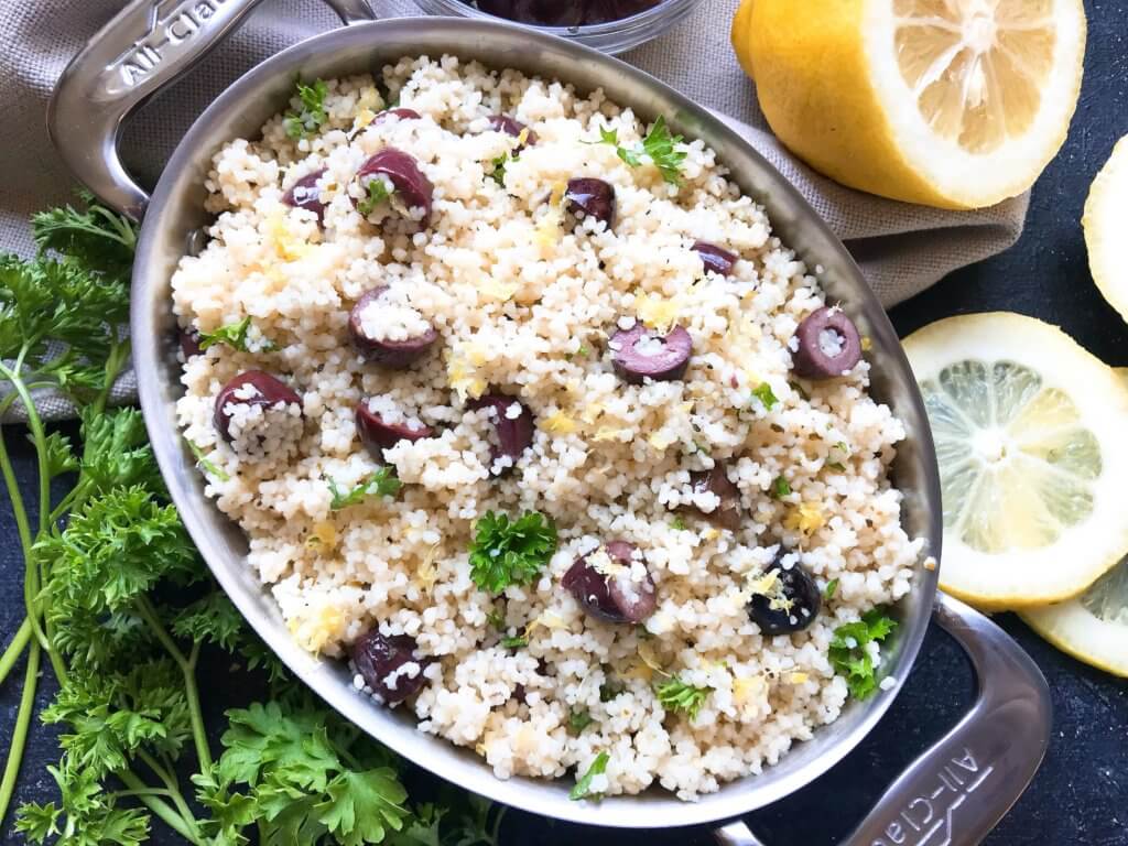 Ready in less than 10 minutes, this Vegan Mediterranean Lemon Olive Couscous recipe is full of fresh and bright flavors for a light side dish. Great with chicken, seafood, and vegetables. A simple and easy recipe to make. #fastrecipes #olives #lemon #sidedishrecipes