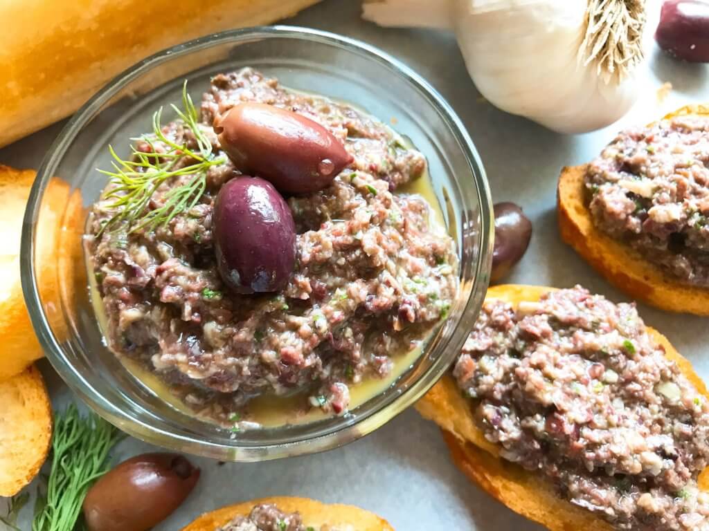 Ready in 5 minutes, this tapenade recipe is vegan, vegetarian, paleo, keto low carb, Whole 30, and gluten free (GF). Perfect as a holiday appetizer for Christmas, Thanksgiving, Easter, and more. Serve with crostini, chicken, pasta, vegetables, and more. Vegan Artichoke Olive Tapenade #holidayappetizer #olive #veganrecipe