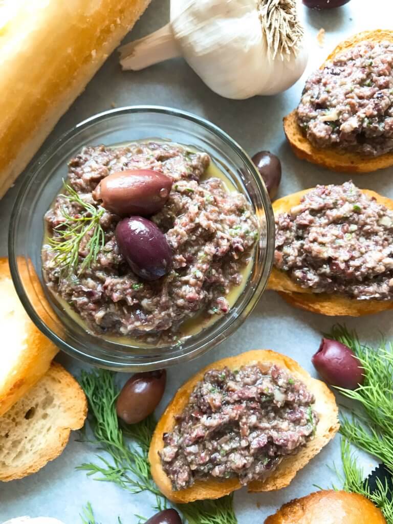 Ready in 5 minutes, this tapenade recipe is vegan, vegetarian, paleo, keto low carb, Whole 30, and gluten free (GF). Perfect as a holiday appetizer for Christmas, Thanksgiving, Easter, and more. Serve with crostini, chicken, pasta, vegetables, and more. Vegan Artichoke Olive Tapenade #holidayappetizer #olive #veganrecipe