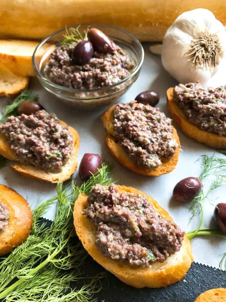 Ready in 5 minutes, this tapenade recipe is vegan, vegetarian, paleo, keto low carb, Whole 30, and gluten free (GF). Perfect as a holiday appetizer for Christmas, Thanksgiving, Easter, and more. Serve with crostini, chicken, pasta, vegetables, and more. Vegan Artichoke Olive Tapenade #holidayappetizer #olive #veganrecipe