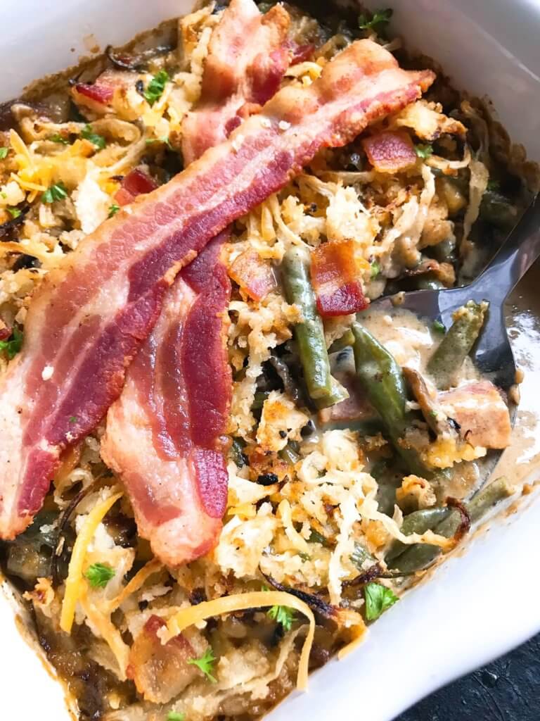 A twist on a classic holiday side dish. Bacon and cheddar cheese enhance a homemade green bean casserole made from scratch. Make in advance for quick assembly on Christmas, Thanksgiving, Easter, or other holiday meals. Bacon Cheddar Green Bean Casserole #thanksgivingrecipes #greenbeancasserole #holidayrecipes #christmasrecipes #baconcheddar