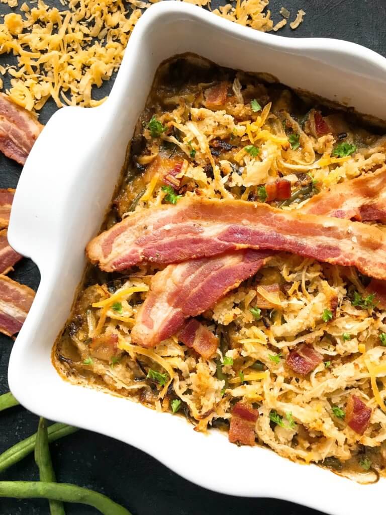 A twist on a classic holiday side dish. Bacon and cheddar cheese enhance a homemade green bean casserole made from scratch. Make in advance for quick assembly on Christmas, Thanksgiving, Easter, or other holiday meals. Bacon Cheddar Green Bean Casserole #thanksgivingrecipes #greenbeancasserole #holidayrecipes #christmasrecipes #baconcheddar