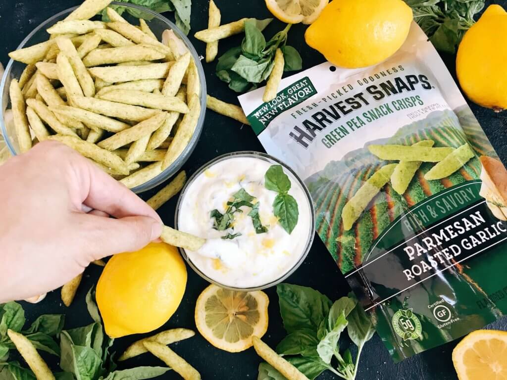 Ready in just minutes, this easy dipping sauce recipe is made with plain Greek yogurt, fresh basil, lemon, and garlic. Dunk your favorite vegetables, chips, or Harvest Snaps! Quick appetizer or snack that is gluten free (gf) and vegetarian. Healthy Lemon Basil Dipping Sauce with Harvest Snaps #appetizerrecipes #glutenfree #vegetarian
