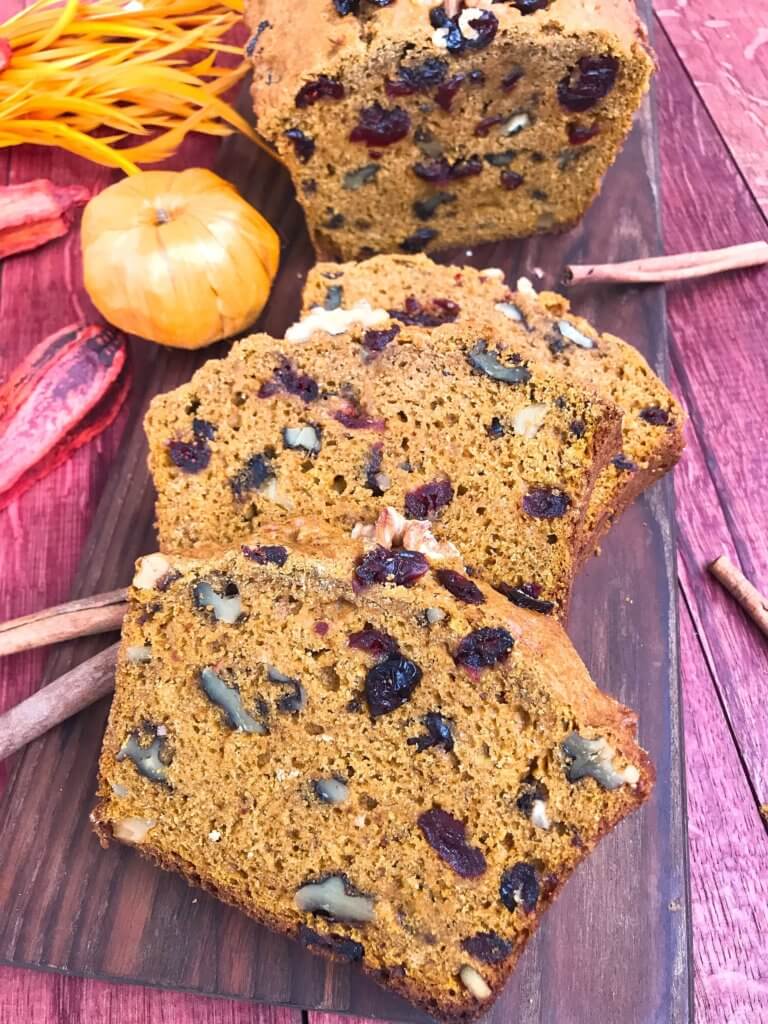 Perfect for fall and Thanksgiving, this Cranberry Walnut Pumpkin Spice Bread recipe is full of fall flavors in comfort food. Simple to make and vegetarian, great for breakfast, dessert, or a snack. #pumpkinbread #pumpkinspice #bread