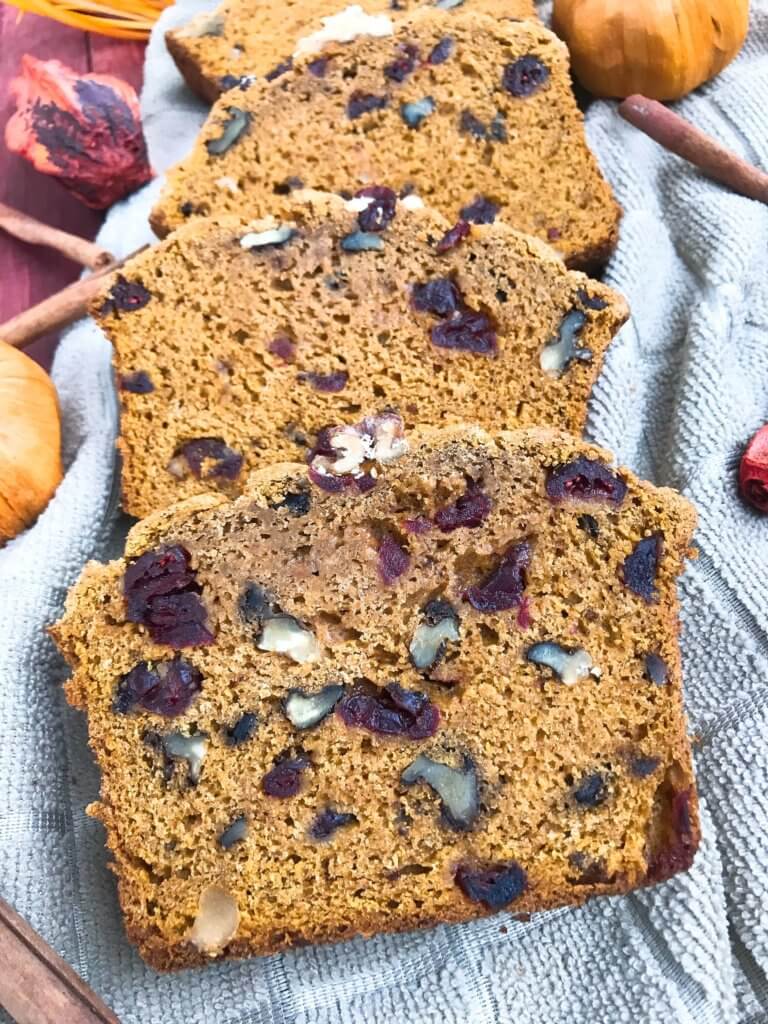 Perfect for fall and Thanksgiving, this Cranberry Walnut Pumpkin Spice Bread recipe is full of fall flavors in comfort food. Simple to make and vegetarian, great for breakfast, dessert, or a snack. #pumpkinbread #pumpkinspice #bread