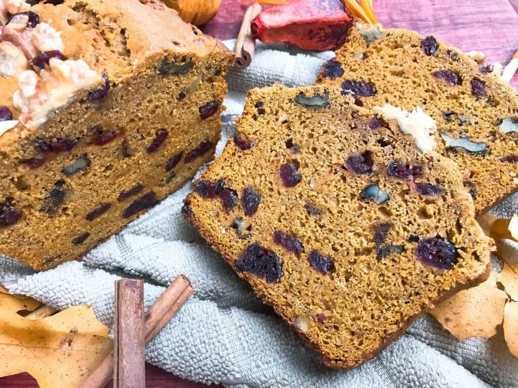 Perfect for fall and Thanksgiving, this Cranberry Walnut Pumpkin Spice Bread recipe is full of fall flavors in comfort food. Simple to make and vegetarian, great for breakfast, dessert, or a snack. #pumpkinbread #pumpkinspice #bread