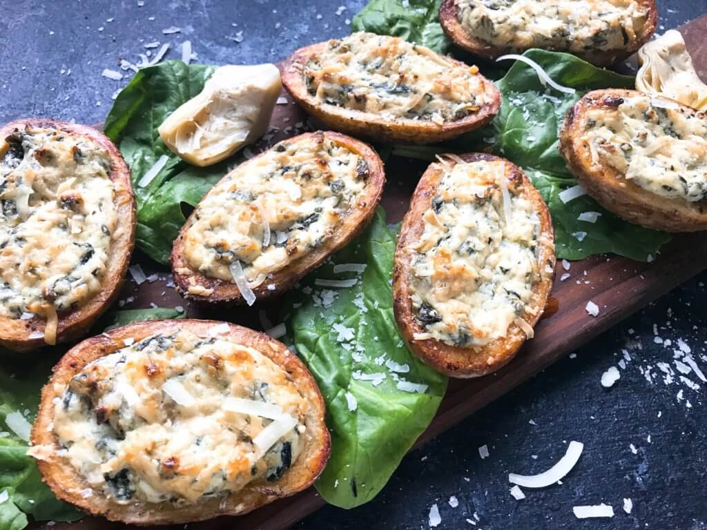 Classic spinach artichoke dip stuffed in potato skin shells. Great recipe for game day, holiday entertaining, and party appetizer. Vegetarian and gluten free. Spinach Artichoke Dip Potato Skins #appetizer #spinachartichokedip