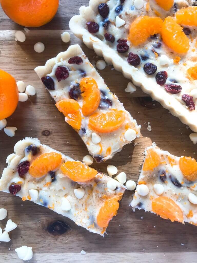 A fast and easy dessert recipe ready in just 30 minutes. Cranberry Orange Tart has a soft cookie shell with a cream cheese filling mixed with dried cranberries, orange zest, and white chocolate chips. #christmasdessert #holidayrecipes #holidaybaking #fruittart