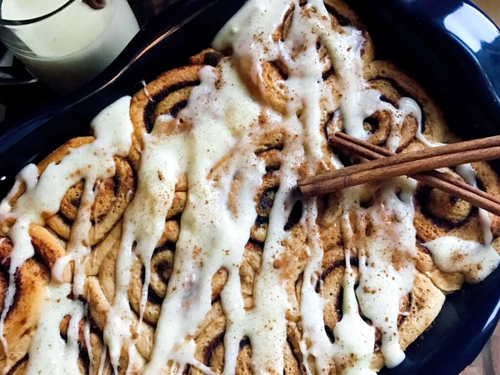 Eggnog Cinnamon Rolls are perfect for Christmas morning! Celebrate winter and the holiday season with a fun breakfast or brunch recipe. Eggnog, cinnamon, and nutmeg flavor these rolls. A great vegetarian food to make in advance. #christmasbrunch #christmasbreakfast #cinnamonrolls #eggnogrecipes #christmasrecipes