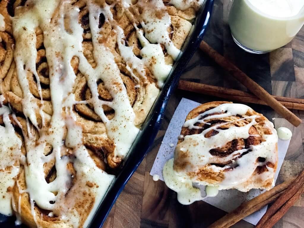 Eggnog Cinnamon Rolls are perfect for Christmas morning! Celebrate winter and the holiday season with a fun breakfast or brunch recipe. Eggnog, cinnamon, and nutmeg flavor these rolls. A great vegetarian food to make in advance. #christmasbrunch #christmasbreakfast #cinnamonrolls #eggnogrecipes #christmasrecipes