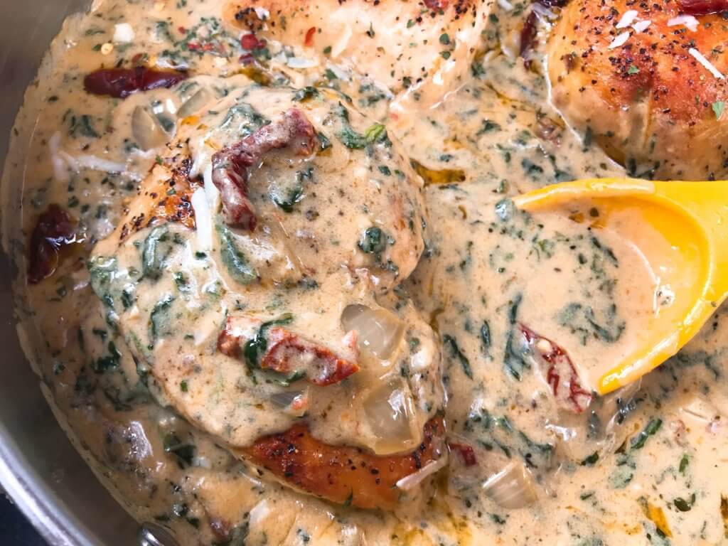 Ready in 30 minutes, this quick and simple skillet chicken recipe is perfect for busy nights. Sundried tomatoes, spinach, and chicken in a creamy Parmesan cheese sauce. Gluten free. Creamy Parmesan Tuscan Chicken #chickenrecipes #quickrecipes #easyrecipes #glutenfreerecipes