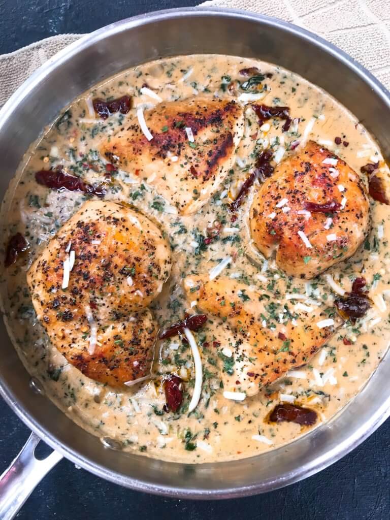 Ready in 30 minutes, this quick and simple skillet chicken recipe is perfect for busy nights. Sundried tomatoes, spinach, and chicken in a creamy Parmesan cheese sauce. Gluten free. Creamy Parmesan Tuscan Chicken #chickenrecipes #quickrecipes #easyrecipes #glutenfreerecipes