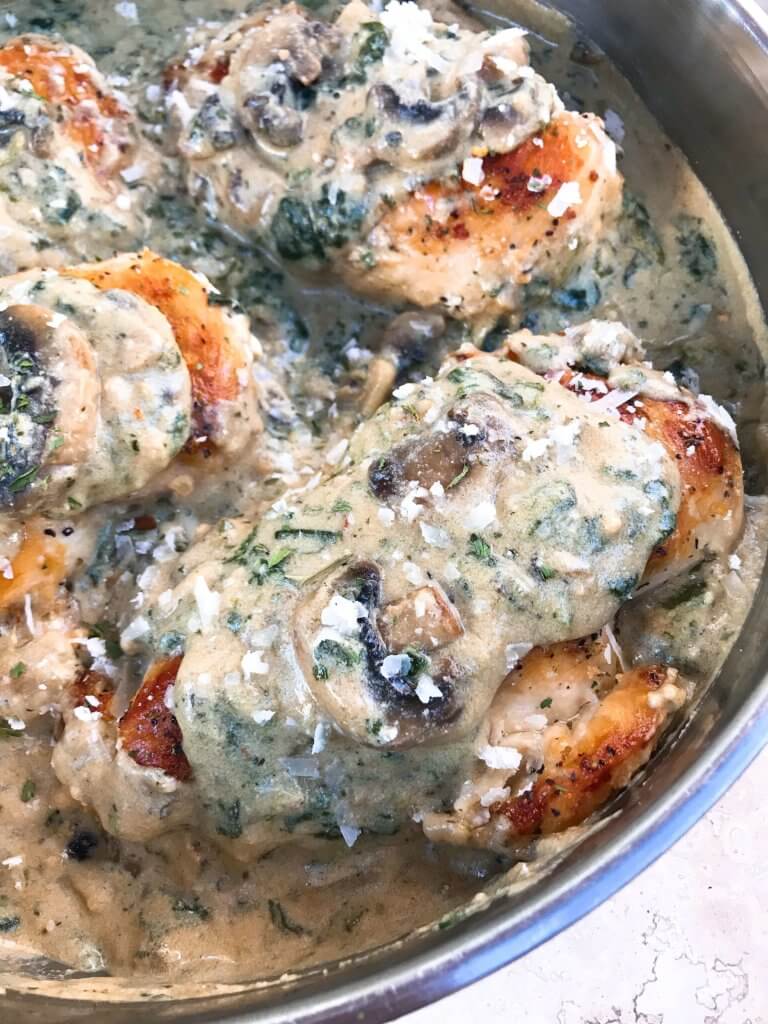 Ready in just 30 minutes, this Skillet Chicken Florentine one pot dinner is quick and simple to make. Chicken is browned and cooked in a creamy Parmesan sauce with spinach and mushrooms. Gluten free. #chickendinner #chickenrecipes #onepotrecipes #onepotdinner #glutenfreerecipes