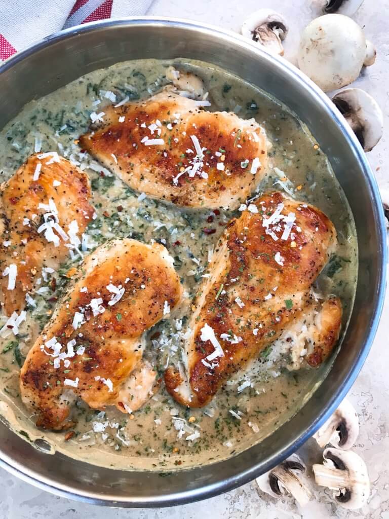 Ready in just 30 minutes, this Skillet Chicken Florentine one pot dinner is quick and simple to make. Chicken is browned and cooked in a creamy Parmesan sauce with spinach and mushrooms. Gluten free. #chickendinner #chickenrecipes #onepotrecipes #onepotdinner #glutenfreerecipes