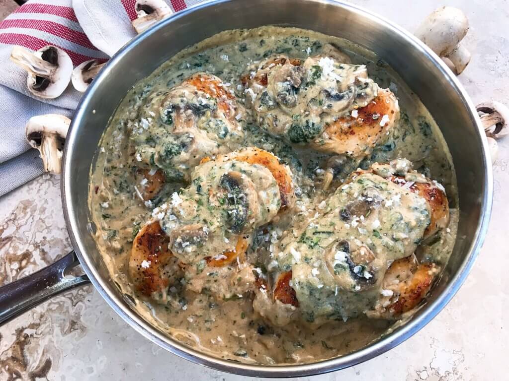 Ready in just 30 minutes, this Skillet Chicken Florentine one pot dinner is quick and simple to make. Chicken is browned and cooked in a creamy Parmesan sauce with spinach and mushrooms. Gluten free. #chickendinner #chickenrecipes #onepotrecipes #onepotdinner #glutenfreerecipes