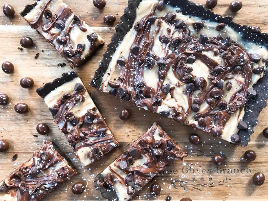 A quick and easy indulgent dessert, this Chocolate Espresso Tart is ready in just 30 minutes. A soft cocoa cookie shell is filled with a coffee cream cheese, Nutella chocolate hazelnut spread, chocolate espresso beans, and chocolate chips. #chocolateespresso #chocolatedesserts #fastdesserts #tartrecipes #chocolaterecipes