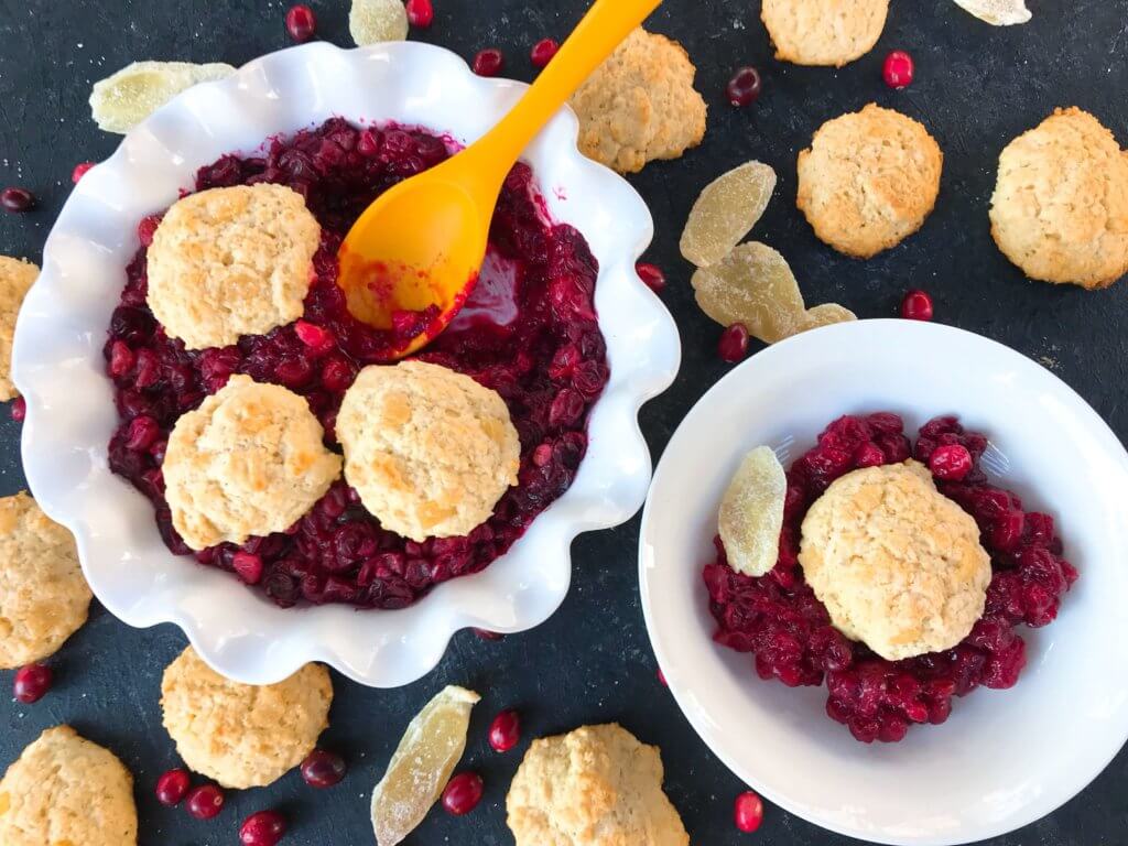 Holiday Cranberry Ginger Cobbler is a perfect quick and simple Christmas or Thanksgiving dessert ready in 30-45 minutes. A cranberry ginger filling is topped with light ginger cinnamon biscuits. A perfect holiday dessert. #christmasdessert #thanksgivingdessert #holidaydessert #cranberryrecipes