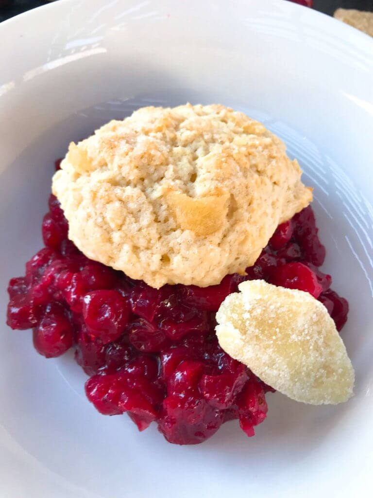 Holiday Cranberry Ginger Cobbler is a perfect quick and simple Christmas or Thanksgiving dessert ready in 30-45 minutes. A cranberry ginger filling is topped with light ginger cinnamon biscuits. A perfect holiday dessert. #christmasdessert #thanksgivingdessert #holidaydessert #cranberryrecipes