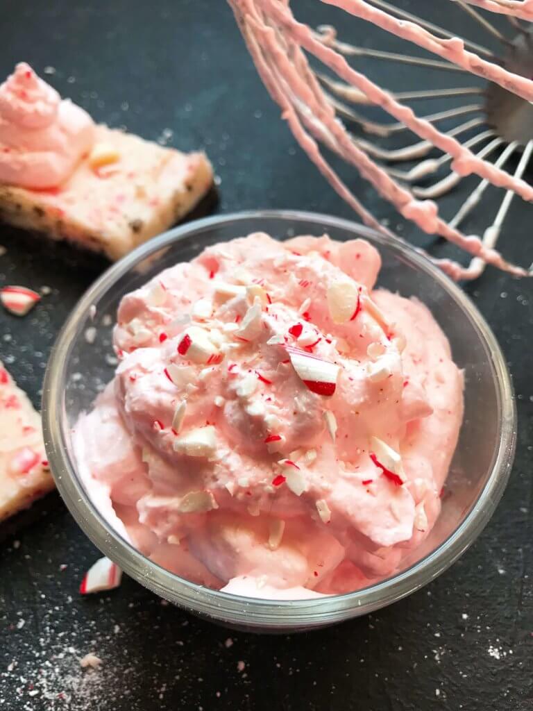 A fast and simple 5 minute whipped cream. Peppermint Whipped Cream is made with just three ingredients for your holiday desserts. #holidaydesserts #easydesserts #whippedcream #whipcream #peppermint