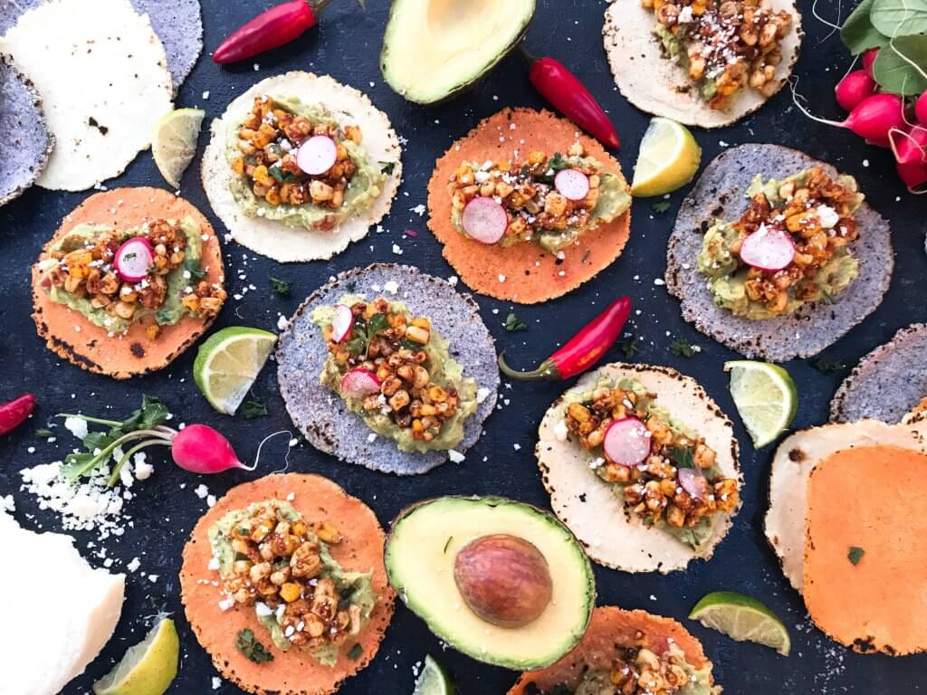 Ready in 15 minutes, these Mexican Street Corn Guacamole Tacos are a fast and simple dinner recipe. Fresh guacamole and corn salsa are layered for a healthy Mexican recipe and quick dinner. Vegetarian and gluten free. Vegan friendly. #healthyrecipes #healthyvegetarian #tacorecipes #vegetarianrecipes #glutenfreerecipes