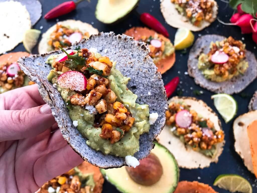 Ready in 15 minutes, these Mexican Street Corn Guacamole Tacos are a fast and simple dinner recipe. Fresh guacamole and corn salsa are layered for a healthy Mexican recipe and quick dinner. Vegetarian and gluten free. Vegan friendly. #healthyrecipes #healthyvegetarian #tacorecipes #vegetarianrecipes #glutenfreerecipes