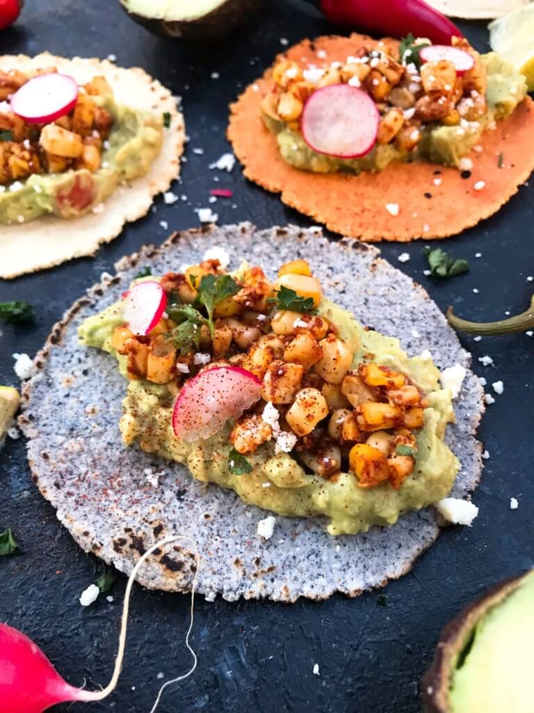 Ready in 15 minutes, these Mexican Street Corn Guacamole Tacos are a fast and simple dinner recipe. Fresh guacamole and corn salsa are layered for a healthy Mexican recipe and quick dinner. Vegetarian and gluten free. Vegan friendly. #healthyrecipes #healthyvegetarian #tacorecipes #vegetarianrecipes #glutenfreerecipes