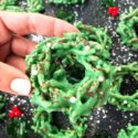 A hand holding one No Bake Christmas Wreath Cookie