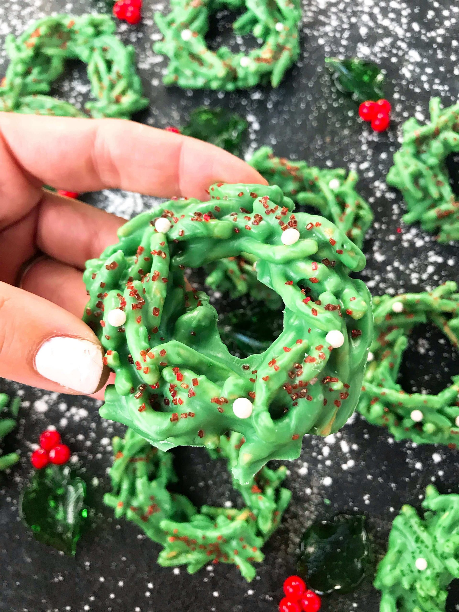 A hand holding one No Bake Christmas Wreath Cookie