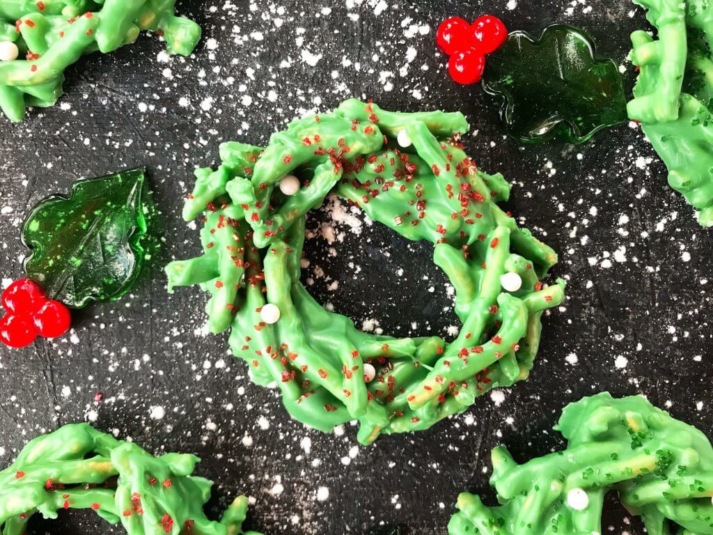 A close up of a No Bake Christmas Wreath Cookies on a black background