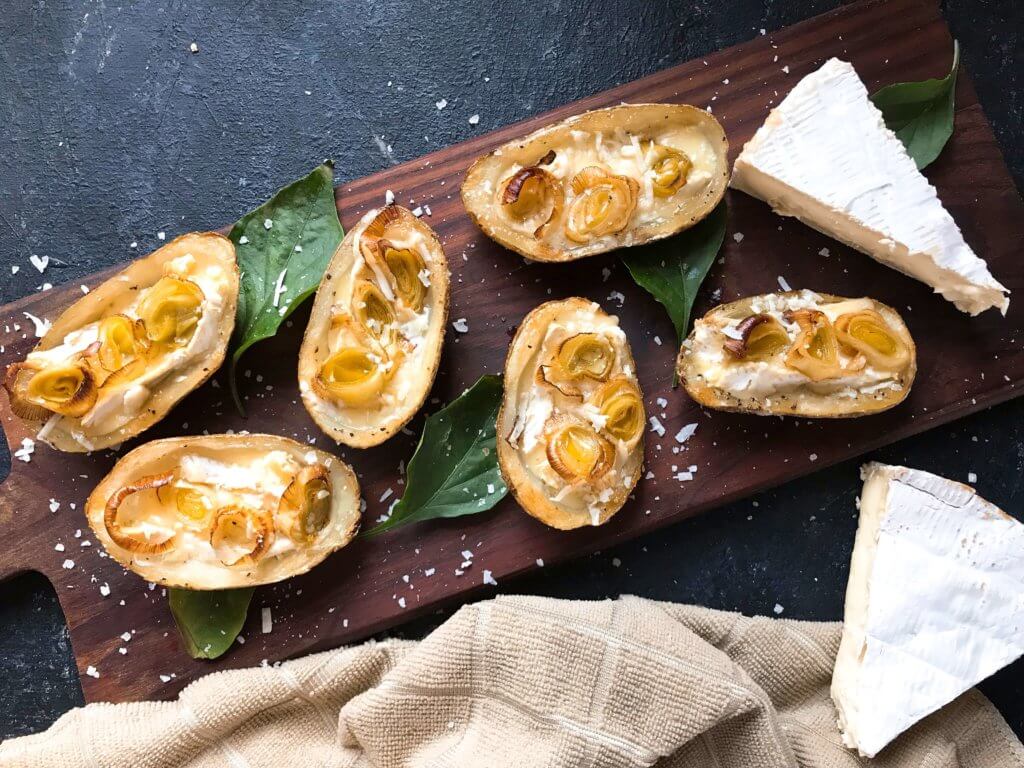 A simple snack recipe for game day and entertaining. Roasted Leek and Brie Potato Skins are vegetarian and gluten free. Creamy cheese and roasted leeks in a potato skin shell. Fun party finger food. #appetizerrecipes #glutenfreerecipes #vegetarianrecipes