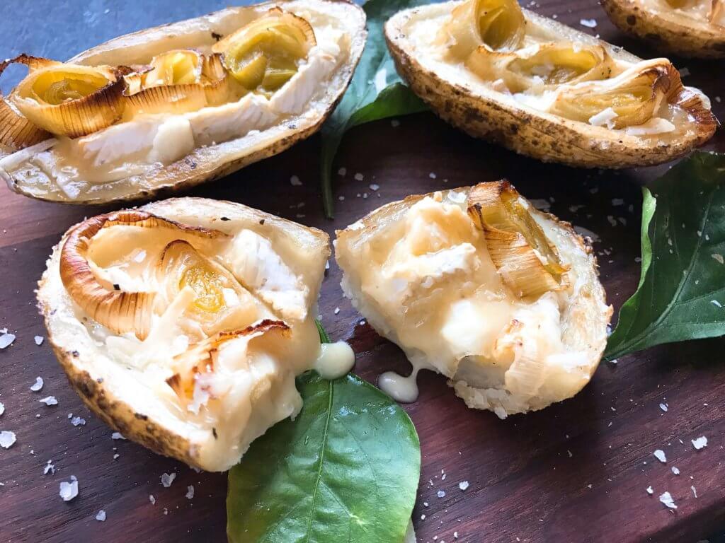 A simple snack recipe for game day and entertaining. Roasted Leek and Brie Potato Skins are vegetarian and gluten free. Creamy cheese and roasted leeks in a potato skin shell. Fun party finger food. #appetizerrecipes #glutenfreerecipes #vegetarianrecipes