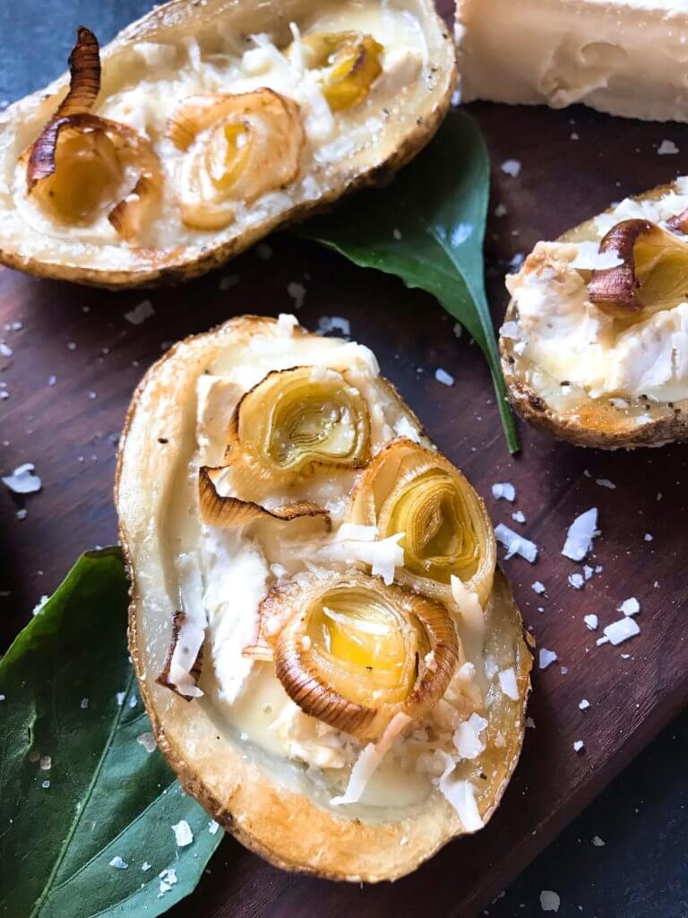 A simple snack recipe for game day and entertaining. Roasted Leek and Brie Potato Skins are vegetarian and gluten free. Creamy cheese and roasted leeks in a potato skin shell. Fun party finger food. #appetizerrecipes #glutenfreerecipes #vegetarianrecipes