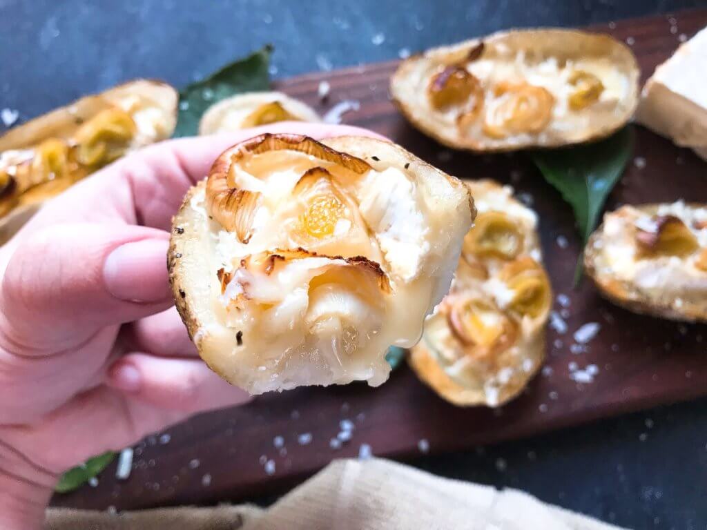 A simple snack recipe for game day and entertaining. Roasted Leek and Brie Potato Skins are vegetarian and gluten free. Creamy cheese and roasted leeks in a potato skin shell. Fun party finger food. #appetizerrecipes #glutenfreerecipes #vegetarianrecipes