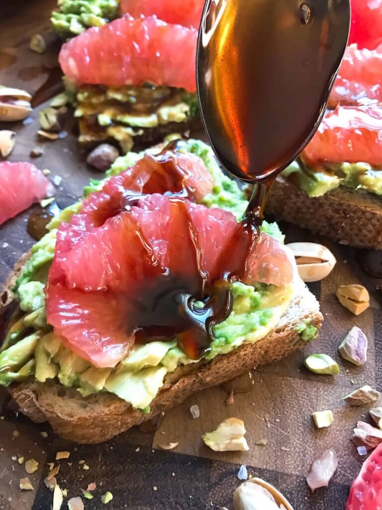 A quick and simple vegan breakfast or brunch recipe ready in just a few minutes. Balsamic Grapefruit Avocado Toast sprinkled with chopped pistachios. #avocadotoast #breakfastrecipes #veganbreakfast