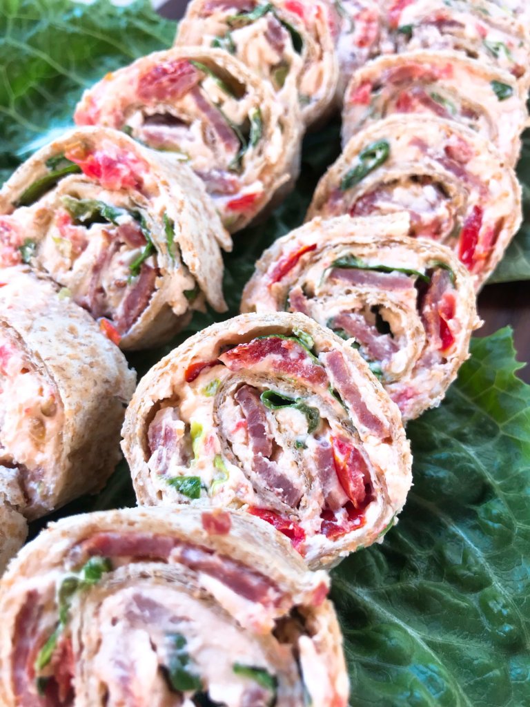 Quick and easy party appetizer. Caesar BLT Pinwheel Roll Ups are bacon, lettuce, tomato, Caesar, and cream cheese rolled up in tortillas. Entertaining finger food recipe. #appetizerrecipes #blt #partyfood