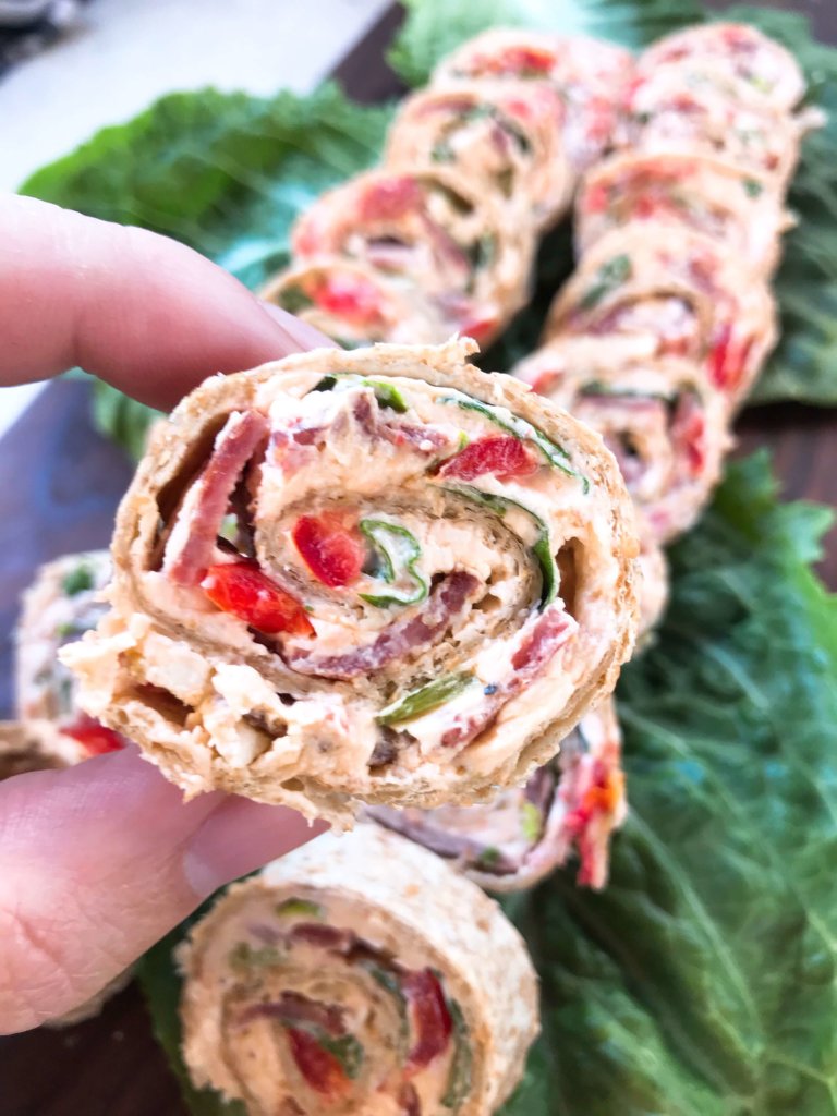 Quick and easy party appetizer. Caesar BLT Pinwheel Roll Ups are bacon, lettuce, tomato, Caesar, and cream cheese rolled up in tortillas. Entertaining finger food recipe. #appetizerrecipes #blt #partyfood
