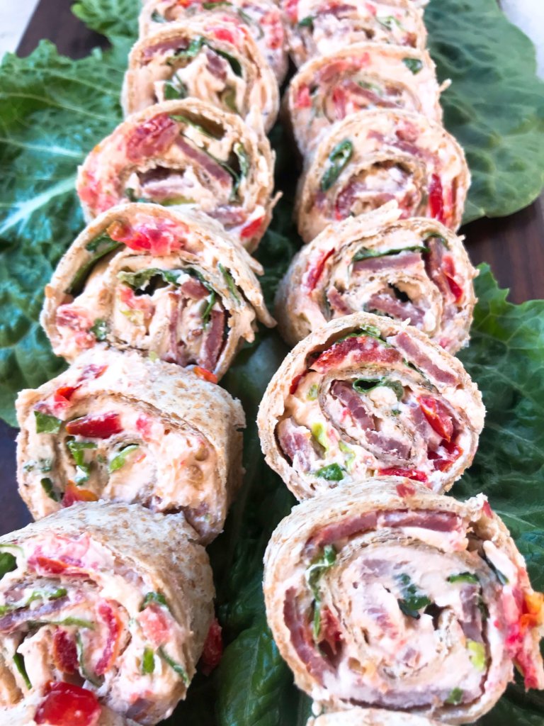 Quick and easy party appetizer. Caesar BLT Pinwheel Roll Ups are bacon, lettuce, tomato, Caesar, and cream cheese rolled up in tortillas. Entertaining finger food recipe. #appetizerrecipes #blt #partyfood