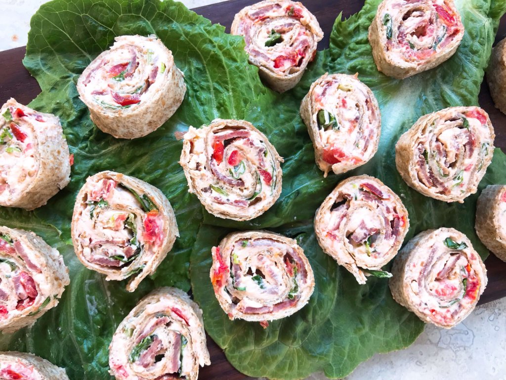 Quick and easy party appetizer. Caesar BLT Pinwheel Roll Ups are bacon, lettuce, tomato, Caesar, and cream cheese rolled up in tortillas. Entertaining finger food recipe. #appetizerrecipes #blt #partyfood