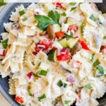 Pin of Creamy Greek Tzatziki Pasta Salad in a gray bowl with title at top