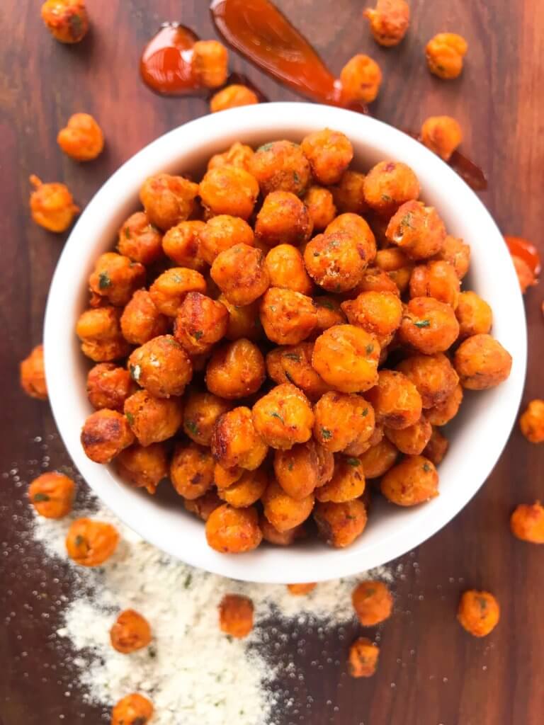 Simple, healthy, and easy game day snack recipe. Buffalo Ranch Roasted Chickpeas are crunchy garbanzo beans covered in buffalo wing sauce and ranch mix. Gluten free and vegetarian. #gamedayrecipes #buffaloranch #roastedchickpeas