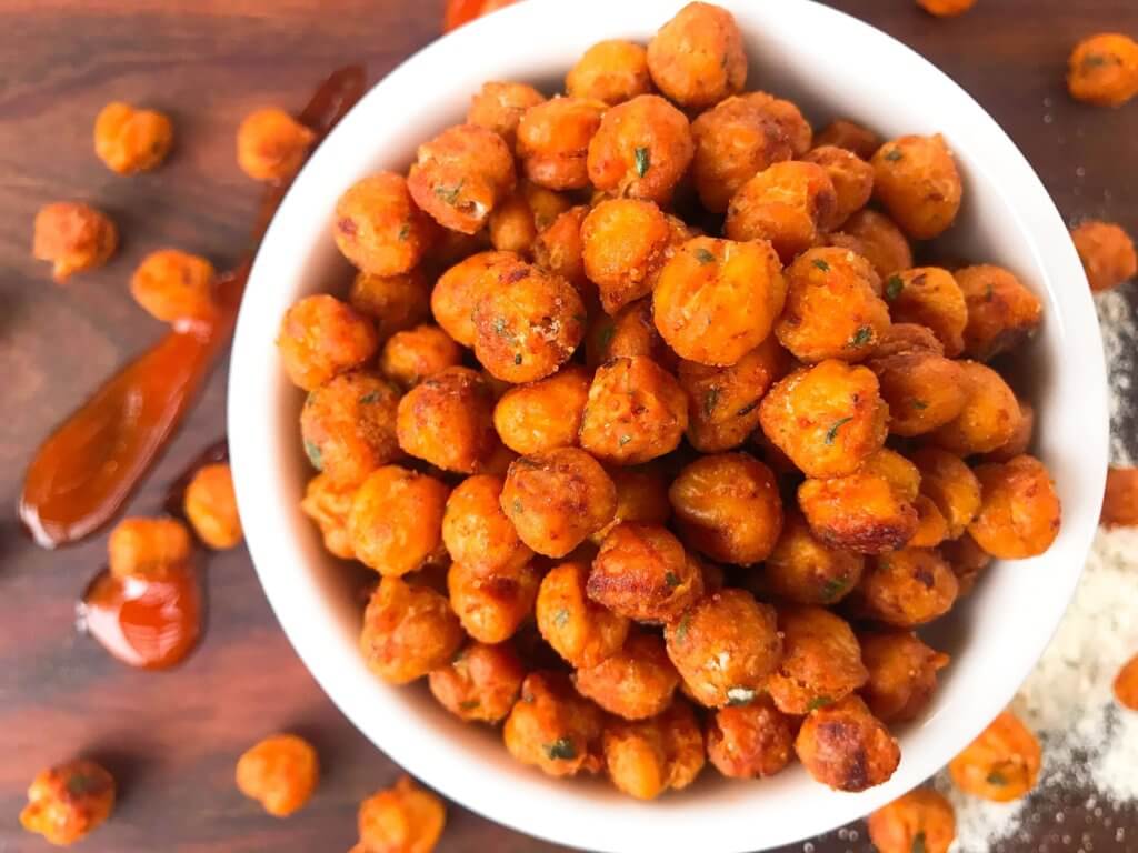 Simple, healthy, and easy game day snack recipe. Buffalo Ranch Roasted Chickpeas are crunchy garbanzo beans covered in buffalo wing sauce and ranch mix. Gluten free and vegetarian. #gamedayrecipes #buffaloranch #roastedchickpeas