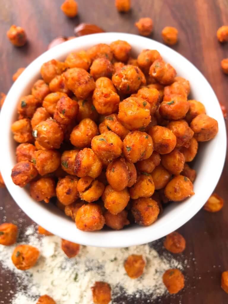 Simple, healthy, and easy game day snack recipe. Buffalo Ranch Roasted Chickpeas are crunchy garbanzo beans covered in buffalo wing sauce and ranch mix. Gluten free and vegetarian. #gamedayrecipes #buffaloranch #roastedchickpeas