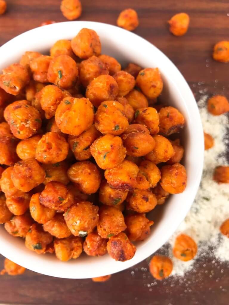 Simple, healthy, and easy game day snack recipe. Buffalo Ranch Roasted Chickpeas are crunchy garbanzo beans covered in buffalo wing sauce and ranch mix. Gluten free and vegetarian. #gamedayrecipes #buffaloranch #roastedchickpeas