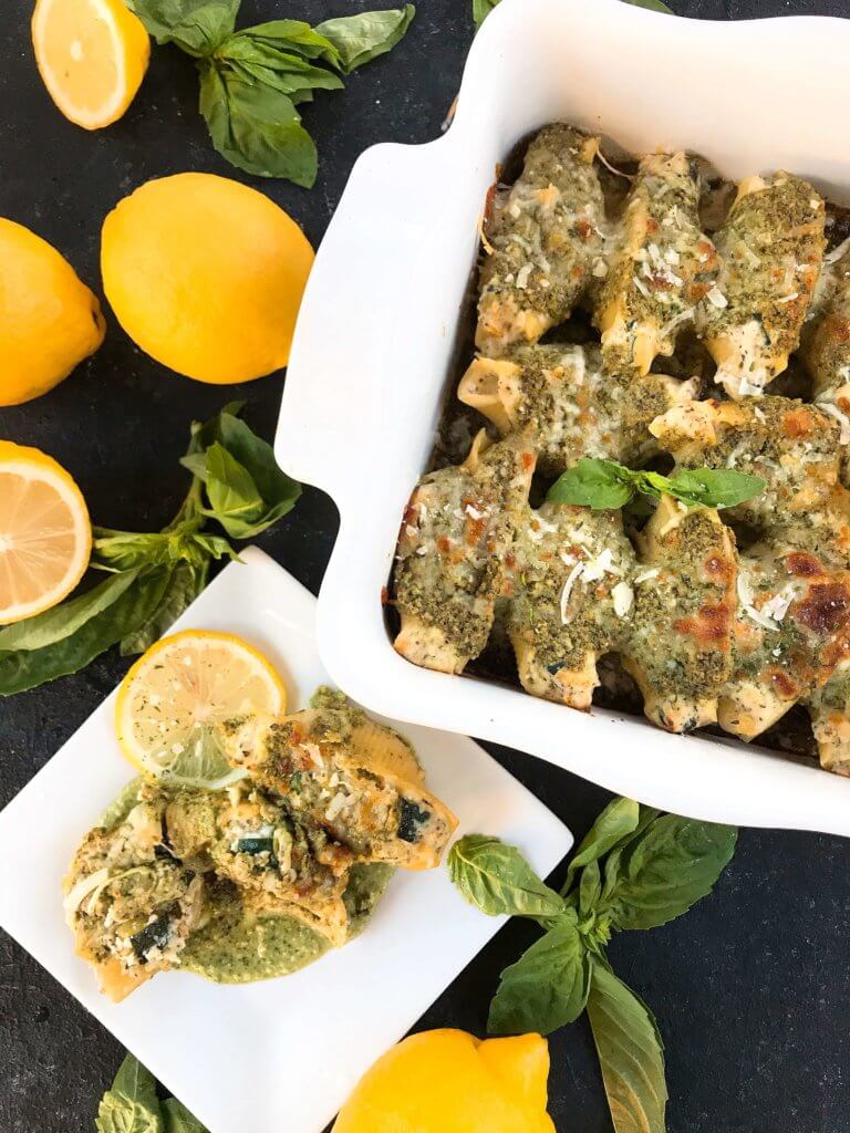 Fresh and bright flavors in a classic Italian dinner recipe. Zucchini Lemon Stuffed Shells with Creamy Pesto Sauce are stuffed with zucchini, lemon, ricotta, and Parmesan cheese. Topped with creamy basil pesto sauce. Vegetarian. #italianrecipes #stuffedshells #zucchinirecipes #pesto