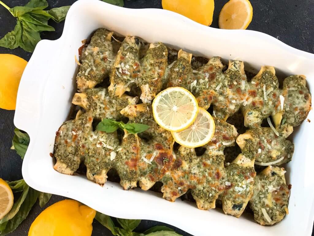 Fresh and bright flavors in a classic Italian dinner recipe. Zucchini Lemon Stuffed Shells with Creamy Pesto Sauce are stuffed with zucchini, lemon, ricotta, and Parmesan cheese. Topped with creamy basil pesto sauce. Vegetarian. #italianrecipes #stuffedshells #zucchinirecipes #pesto