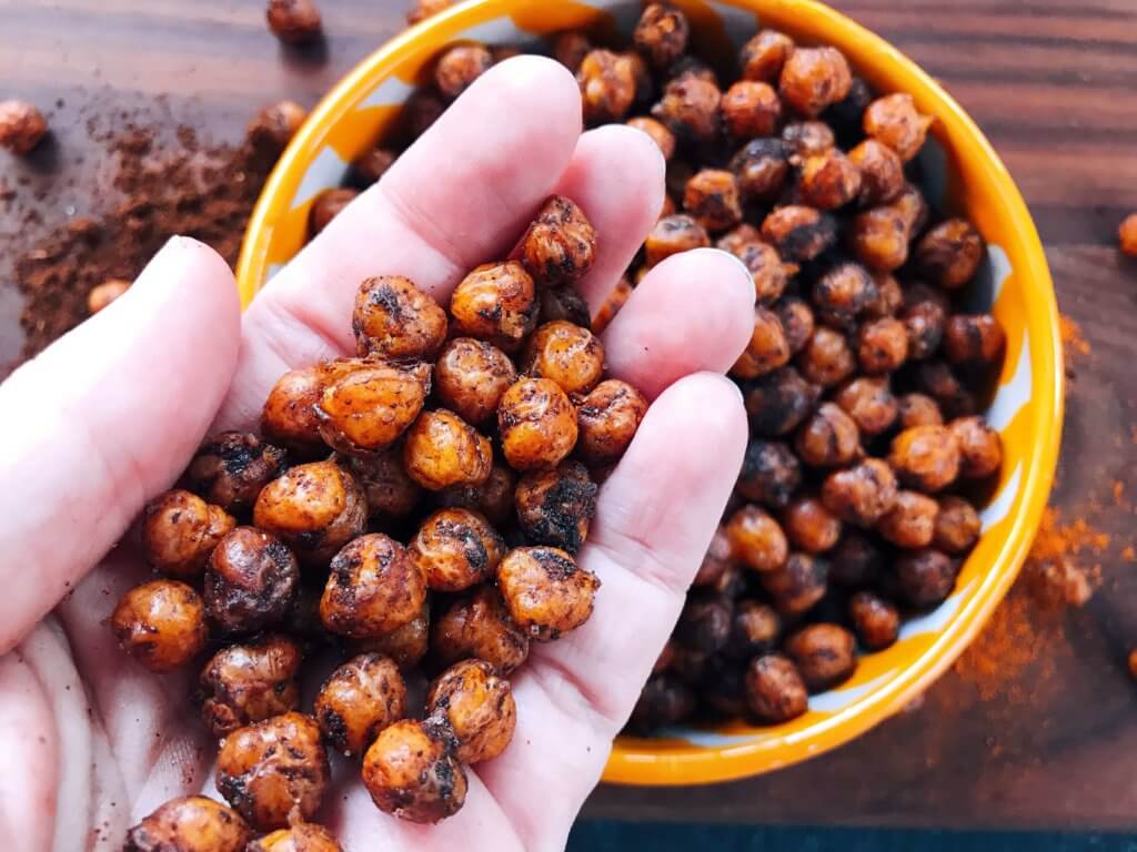 A healthy, vegan, dairy free, gluten free snack or party appetizer recipe. Healthy game day recipe. Simple and easy to make, Spicy Cocoa Espresso Roasted Chickpeas are coated in cayenne pepper, cocoa and coffee. #fingerfood #gamedayrecipes #healthysnacks
