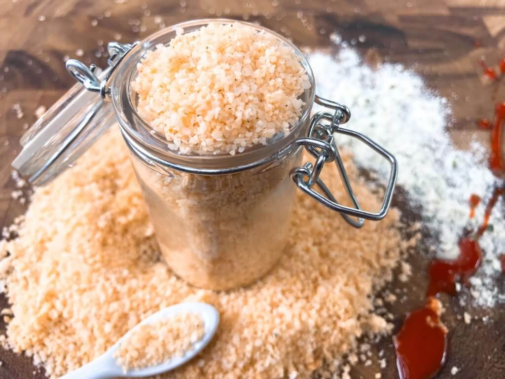 A jar filled with and surrounded by Buffalo Ranch Flavored Salt